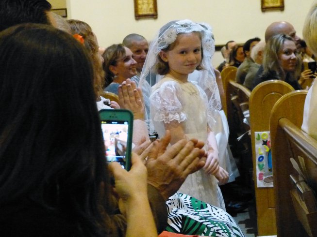 Amber walks down the aisle with her communion group